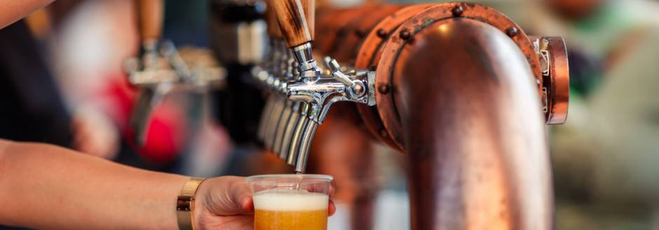bartender pouring a draft beer from the tap